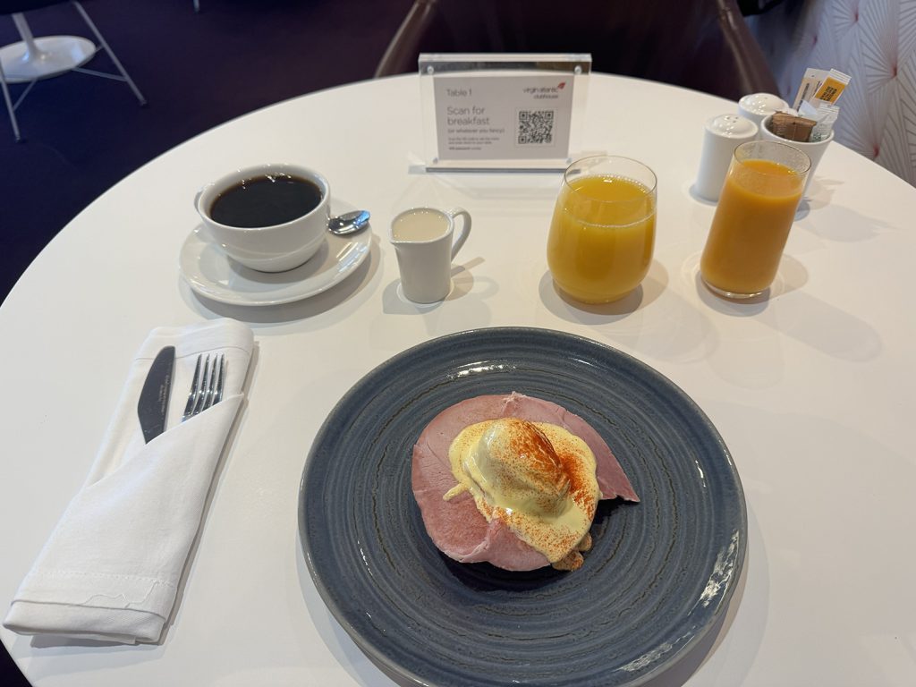 Eggs Benedict and juice in the Virgin Atlantic Revivals Lounge