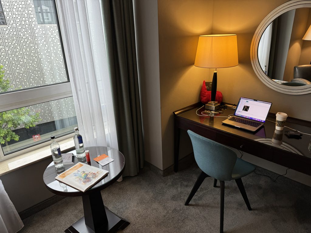 Desk and window in a guestroom at Lindner Hotel Cologne City Plaza