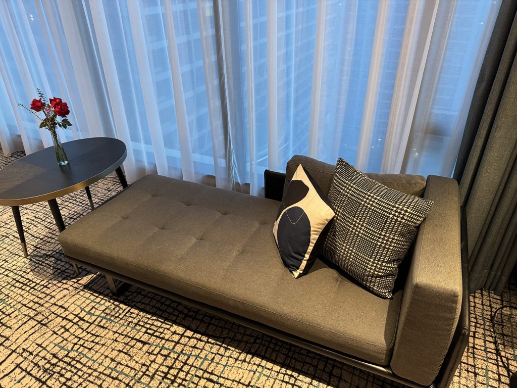 Couch in guest room at Kimpton Maa-Lai Bangkok 